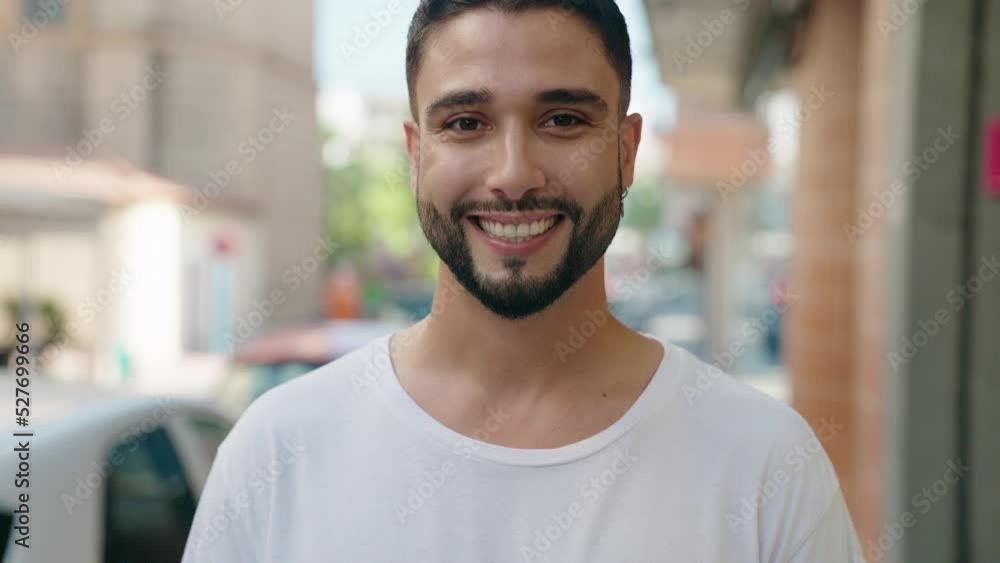 Young arab man smiling confident standing at street Young arab man smiling confident standing at street