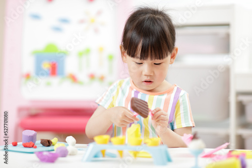 young girl making ice lolly using dough tools for homeschooling