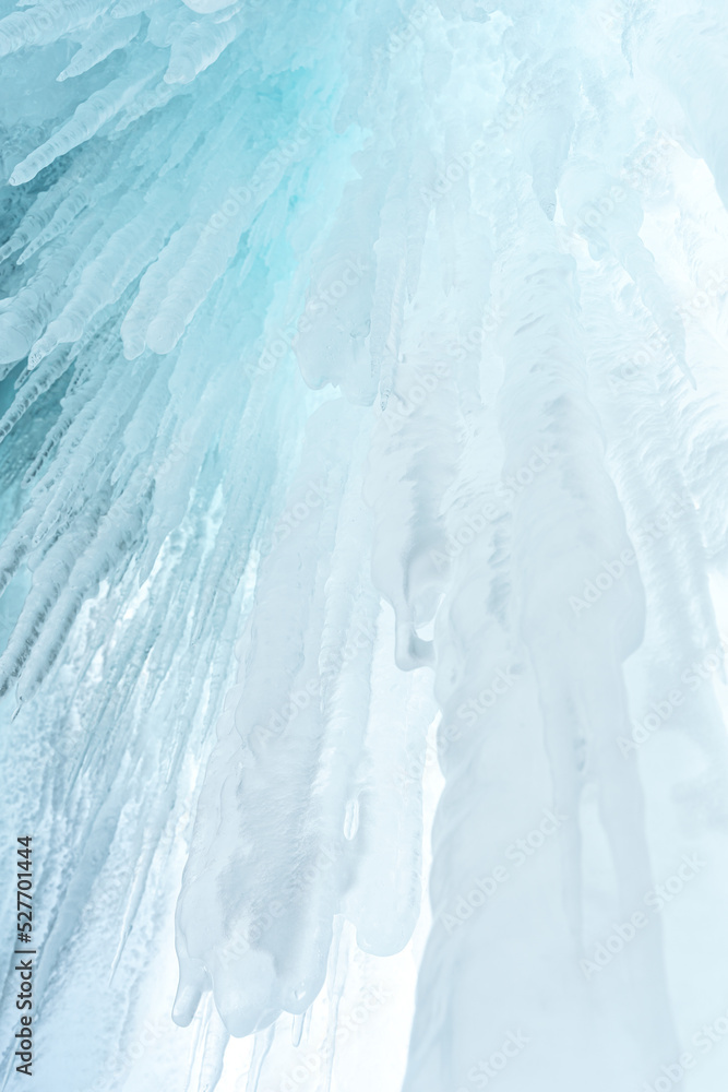 Ice and icicles on the rocks of Ogoy island, Baikal lake, Siberia, Russia. White ice and blue sky abstract winter nature background. Copy space. Ice and icicles on the rocks of Ogoy island, Baikal lake, Siberia, Russia. White ice and blue sky abstract winter nature background. Copy space.