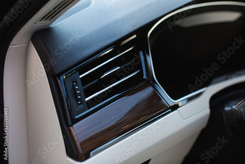 Air vent grill in luxury car. Сar air conditioner, buttons, display. 