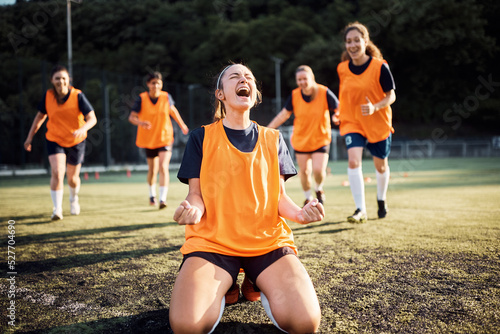Female soccer player celebrates scoring a goal during the match. photo