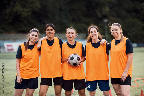 Portrait of happy women's soccer team at stadium looking at camera. © Drazen