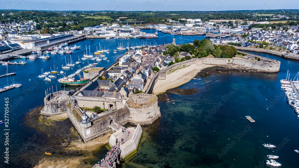 Aerial view of Concarneau, a medieval walled city in Brittany, France - Clock tower in the corner of the fortified island accessed by a stone bridge along the coast of the Atlantic Ocean