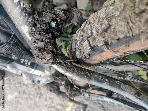 Dirty bike after off-road. Bicycle wheels in the mud. Protectors in action.