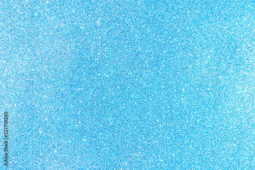 Background with sparkles. Backdrop with glitter. Shiny textured surface. Soft blue