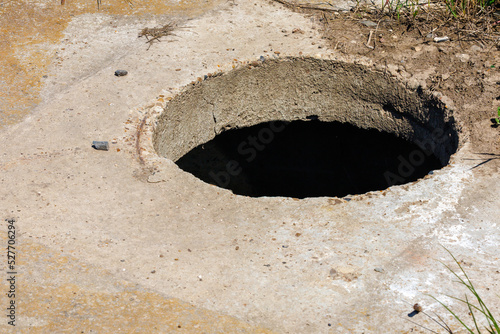 Open sewer without manhole. Background with selective focus and copy space