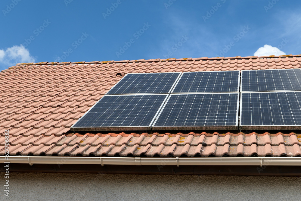 Photovoltaic panels installed on the roof of a house. Solar panels on a roof. Photovoltaic panels installed on the roof of a house. Solar panels on a roof.