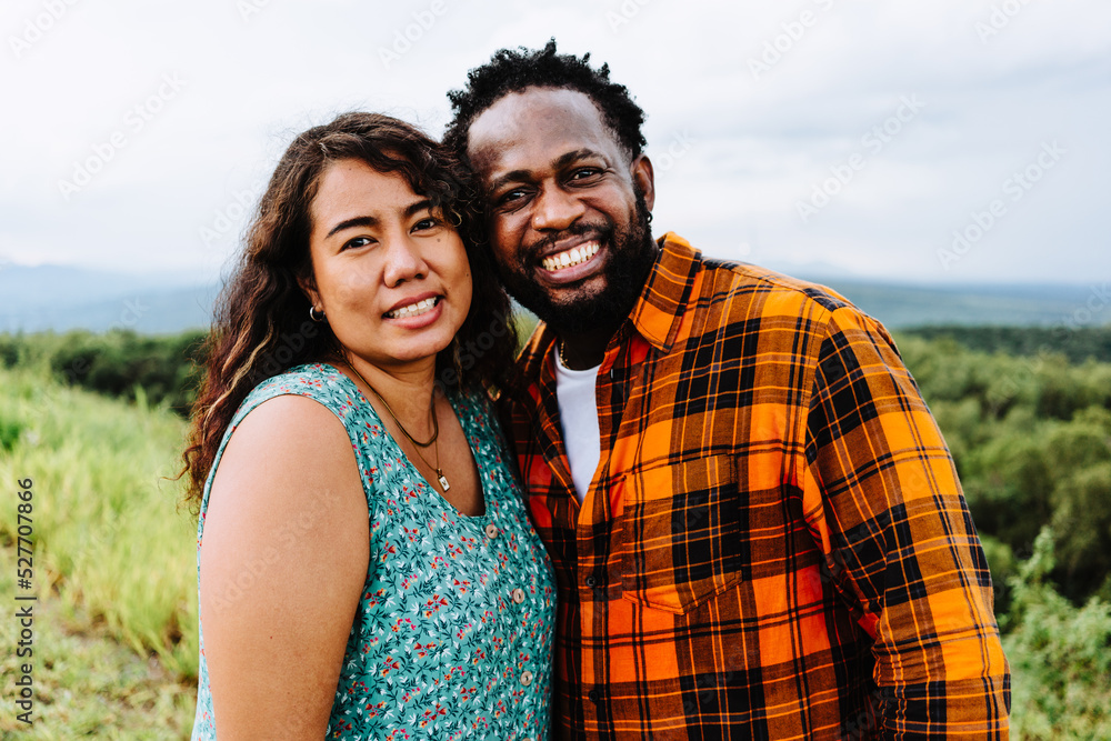 Couple portrait black and Asian at outdoors.