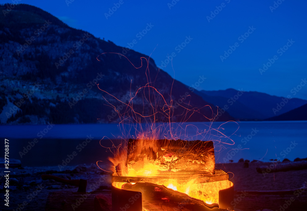 fire beside the lake in the mountains