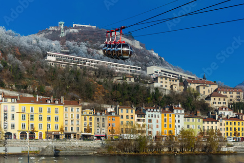 Image of cable cars in Grenoble in autumn over riverside, France.