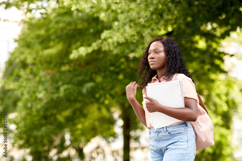 education, school and people concept - african american student girl with notebooks in city education, school and people concept - african american student girl with notebooks in city