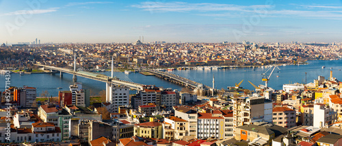 Panoramic view from Galata Tower of Golden Horn bay with cable-stayed metro bridge and highway Ataturk Bridge connecting Beyoglu and Fatih districts in Istanbul, Turkey..