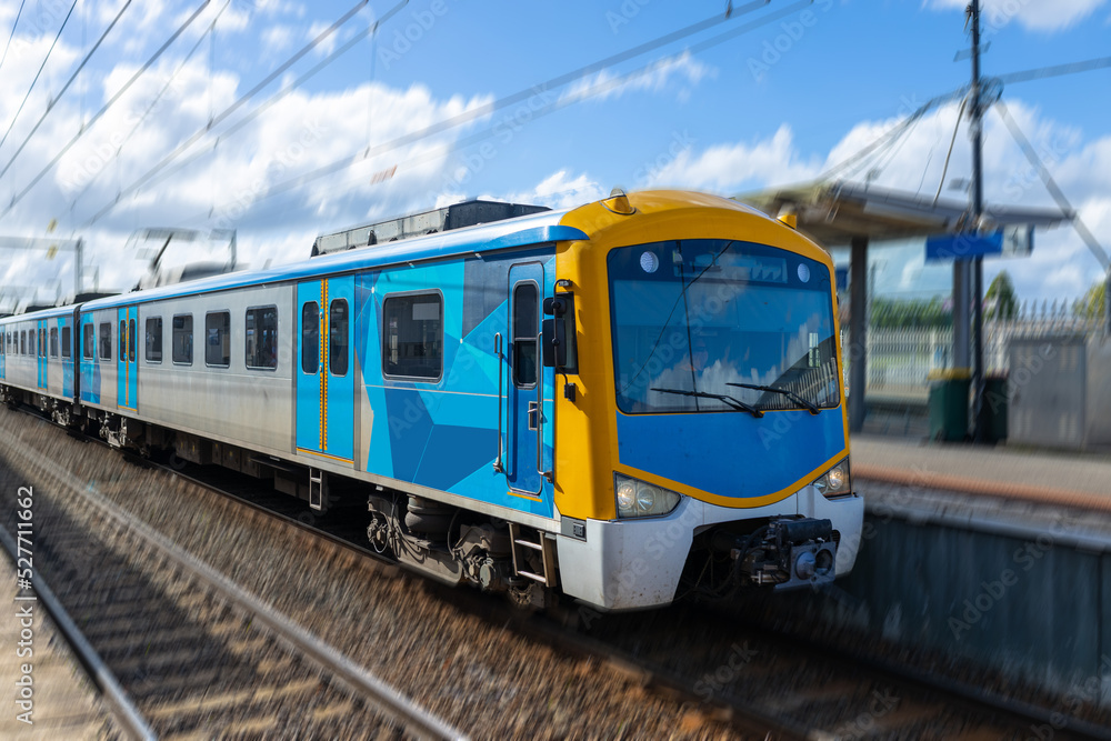 Fototapeta premium Commuter train approaching a train station in Melbourne Victoria Australia