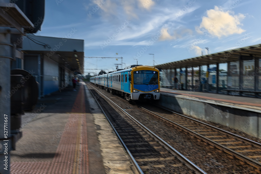 Obraz premium Commuter train approaching a train station in Melbourne Victoria Australia
