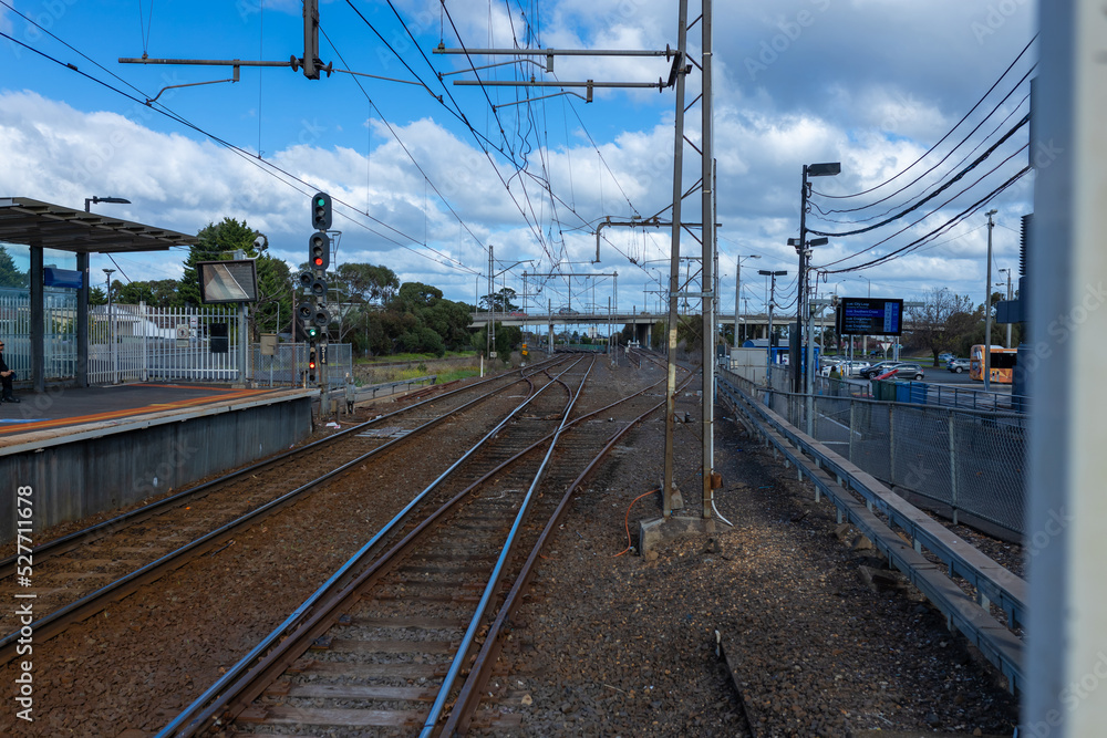Fototapeta premium Commuter train approaching a train station in Melbourne Victoria Australia