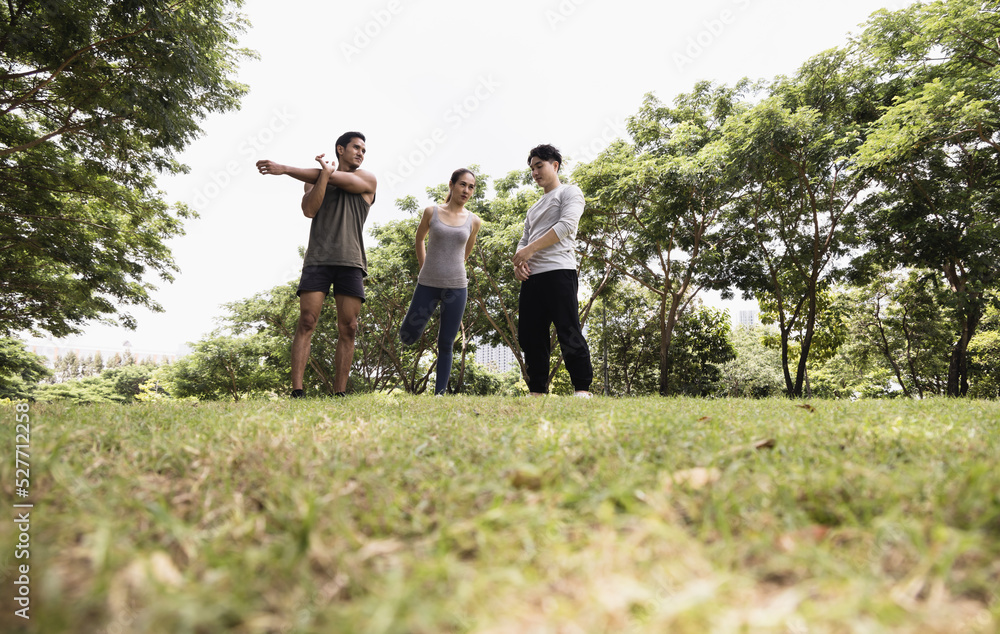 Asian young man and woman stretch body to warm up. Concept for healthy lifestyle and oudoor life. Asian young man and woman stretch body to warm up. Concept for healthy lifestyle and oudoor life.