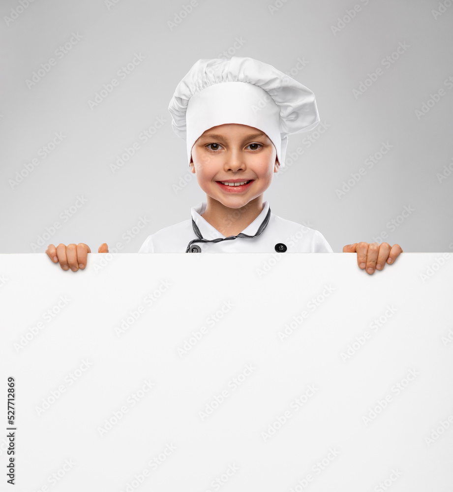 cooking, culinary and profession concept - happy smiling little boy in chef's toque and jacket with white board over grey background cooking, culinary and profession concept - happy smiling little boy in chef's toque and jacket with white board over grey background