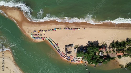 Aerial view of Caraiva beach, Porto Seguro, Bahia, Brazil. Colorful beach tents, sea and river.