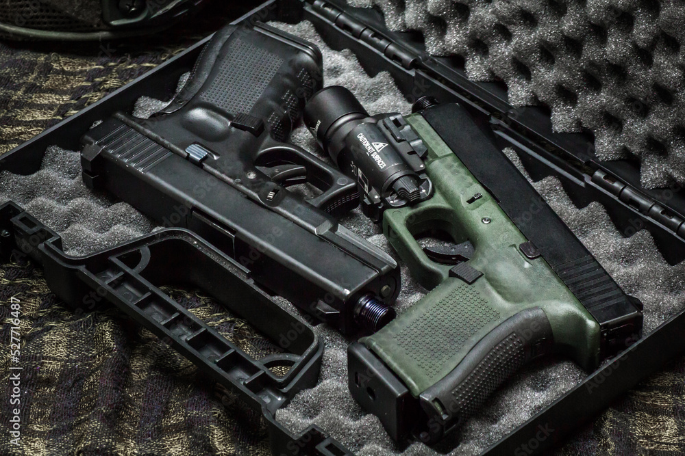 G19 gen4 and gen5 model, Pistol weapon handheld polymer pistol and popular handgun weapon with flashlight attachment olive green color and black. G19 gen4 and gen5 model, Pistol weapon handheld polymer pistol and popular handgun weapon with flashlight attachment olive green color and black.