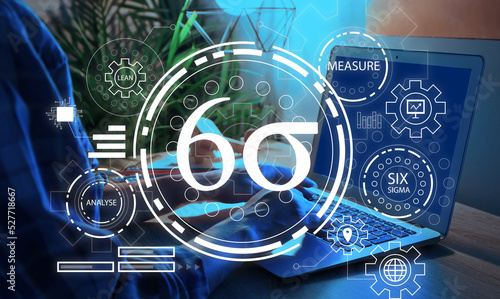 Woman with laptop in office. 6 sigma concept