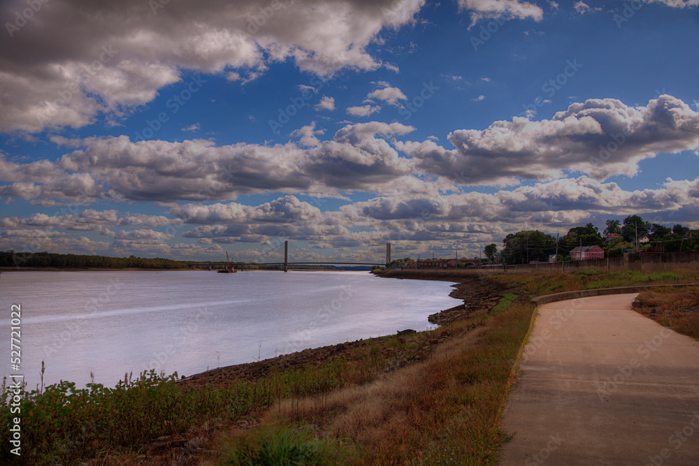 A Walk With the Clouds Mississippi River Walk  Cape Girardeau Missouri   The sky is crowded with monstrous clouds,  a sidewalk takes us along side this mighty river 