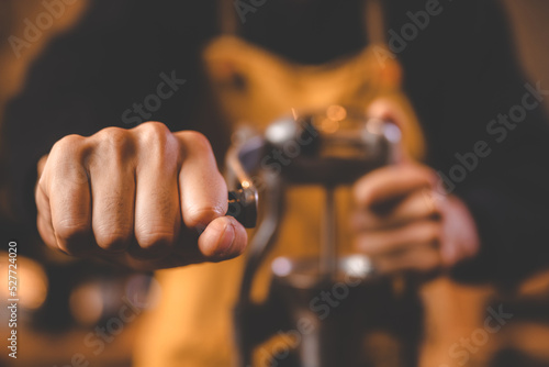 barista holding hand grinde...