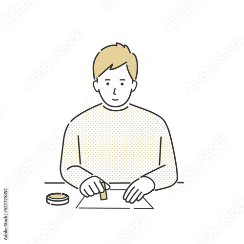 はんこを押す男性