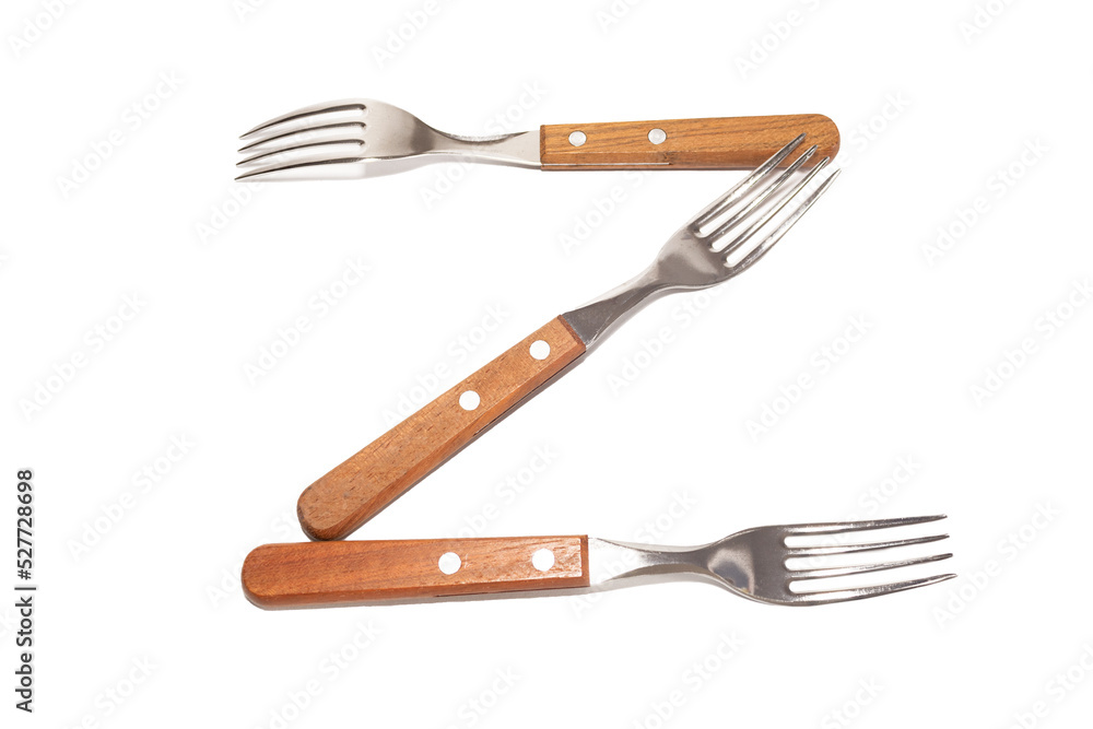3 forks with wooden handles making the letter Z on a white background 3 forks with wooden handles making the letter Z on a white background