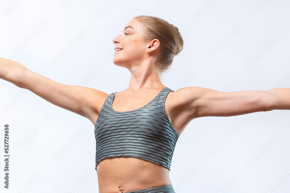 Fototapeta premium Young woman in a yoga pose in a Connecticut studio.