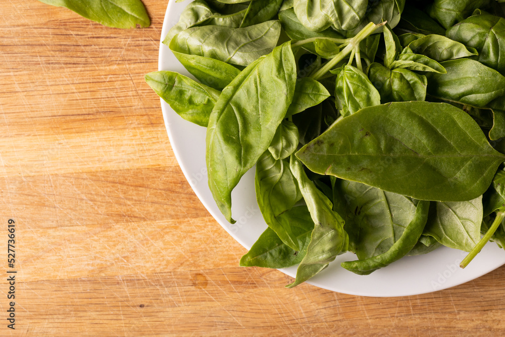 Directly above shot of fresh baby spinach in place on cutting board Directly above shot of fresh baby spinach in place on cutting board