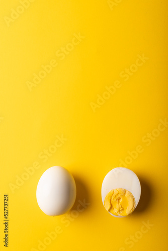 Directly above view of fresh white boiled eggs with copy space on yellow background