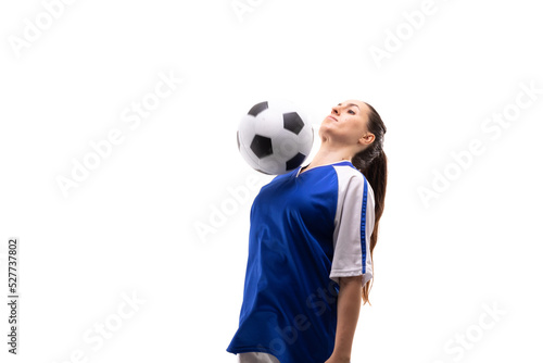 Caucasian young female soccer player hitting soccer ball with chest while playing soccer