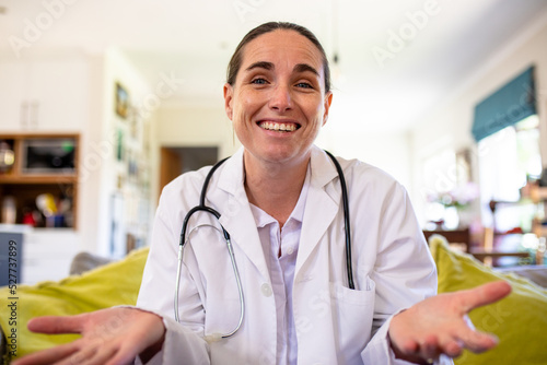 Smiling mature caucasian female doctor explaining on video call, copy space