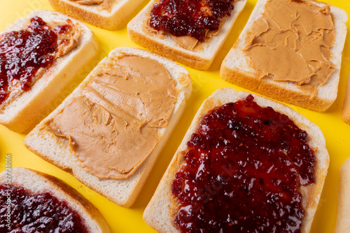 Full frame shot of bread slices with preserves and peanut butter arranged alternatively