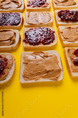 Full frame close-up shot of bread slices with preserves and peanut butter arranged alternatively