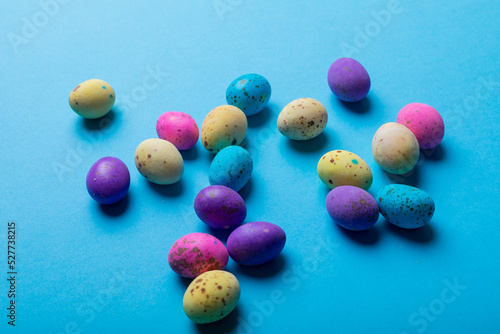 Close-up of colorful eater candies on blue background