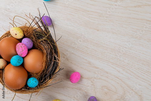 Close-up of eggs and colorful candies in nest on table with empty area during easter