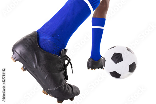 Low section of african american male player kicking soccer ball on white background