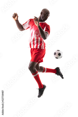 Fototapeta Naklejka Na Ścianę i Meble -  African american young male soccer player controlling ball against white background