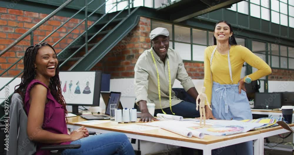 Portrait of happy diverse fashion designers wearing tape measures at office Portrait of happy diverse fashion designers wearing tape measures at office