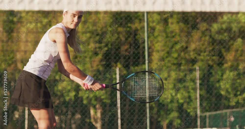 Video of focused caucasian female tennis player holding racket and hitting ball Video of focused caucasian female tennis player holding racket and hitting ball