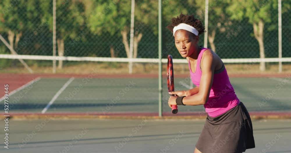 Video of focused african american female tennis player holding racket and hitting ball Video of focused african american female tennis player holding racket and hitting ball