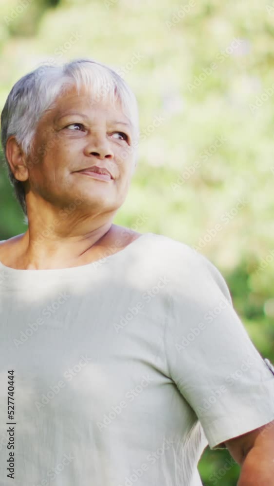 Video of happy biracial senior woman looking at camera in garden Video of happy biracial senior woman looking at camera in garden