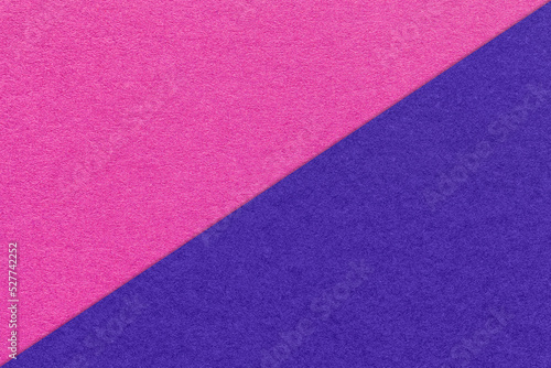 Texture of craft navy blue and purple paper background, half two colors, macro. Vintage dense kraft fuchsia cardboard.