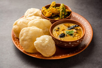 Cholar dal and patol aloo sabzi served with fried Luchi or poori, bengali food