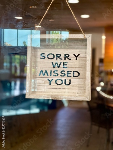 Sorry we missed you sign hangs in a cafe window