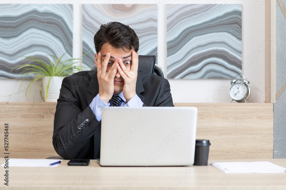 Tired frustrated and overworked business man sitting in the office and thinking about problems in business Tired frustrated and overworked business man sitting in the office and thinking about problems in business