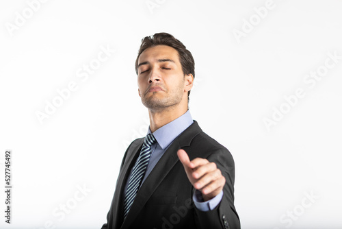 Arrogant businessman demonstrating irritation and haughtiness with hand gesture and face expression isolated on white background