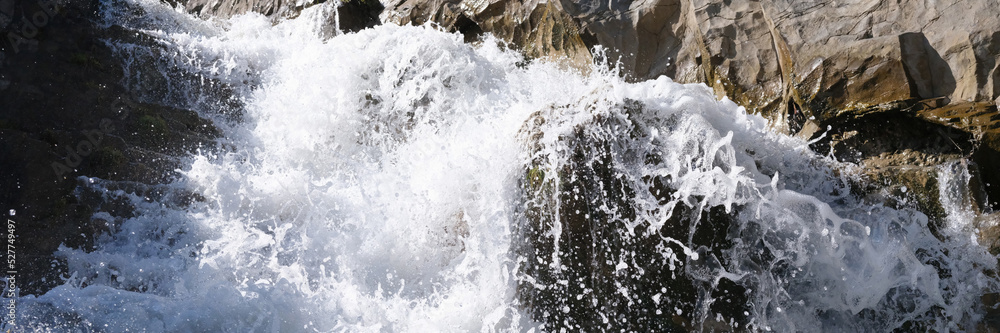 Beautiful fast mountain waterfall with foamy water Beautiful fast mountain waterfall with foamy water