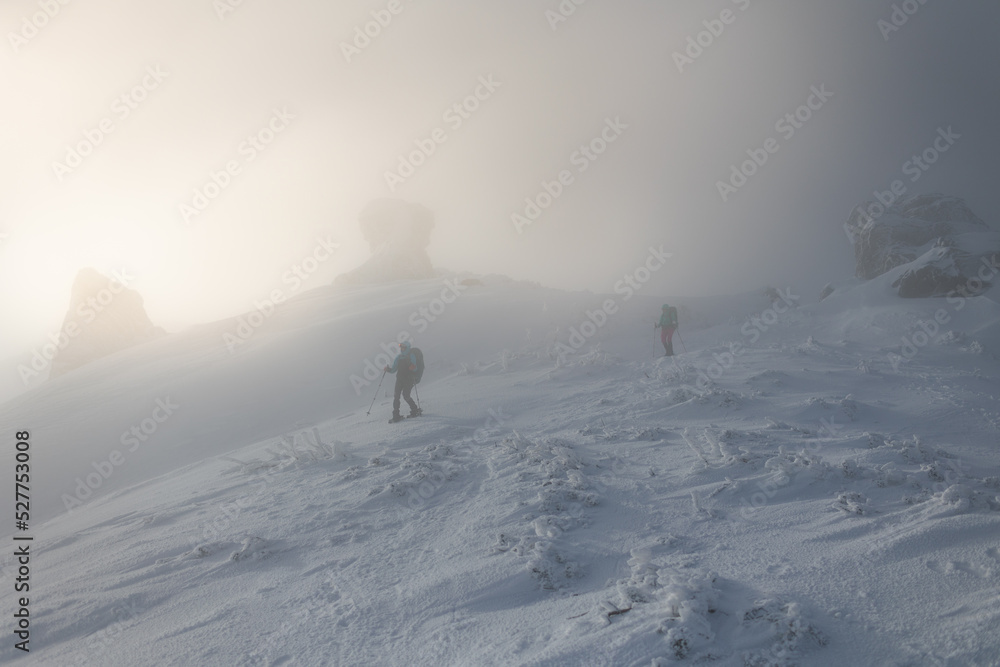 two women climbed to the top of the mountain during a fog